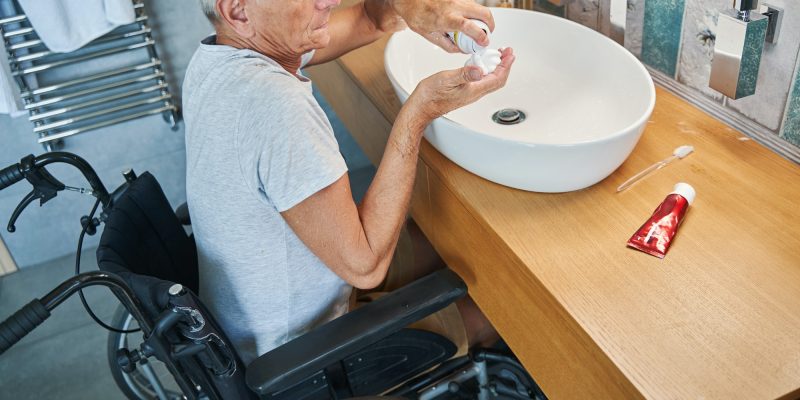 Male with disability pouring shaving cream on his palm